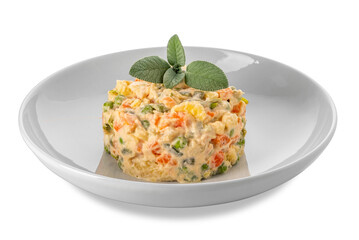 Russian salad in white plate with sage leaves, typical Piedmontese salad Italy made with pieces of vegetables with mayonnaise sauce.
