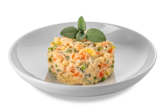 Russian salad in white plate with sage leaves, typical Piedmontese salad Italy made with pieces of vegetables with mayonnaise sauce.