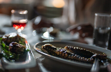 Octopus tentacles in a restaurant in the evening.