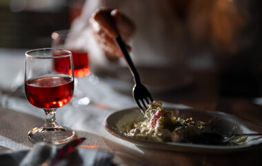 Woman eating salad in a restaurant.