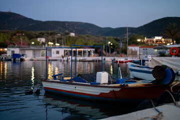 Fototapeta na wymiar Fishing boat at the pier at sunset.