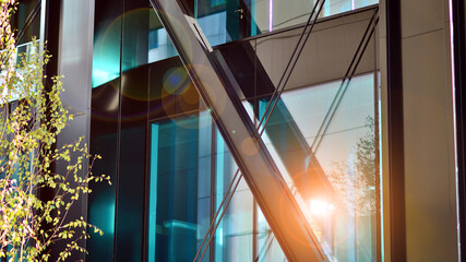 Steel and glass. The subject of modern architecture or construction industry. Modern office building facade with tall steel construction elements and full height windows between. 
