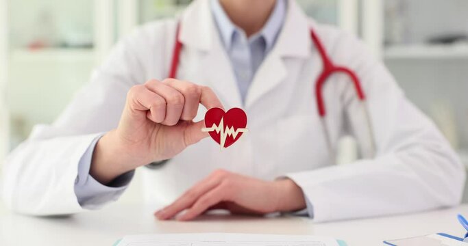 Heart icon in hands of cardiologist in clinic
