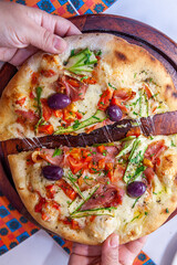 Hands Taking slice of pizza top view close up with melted cheese