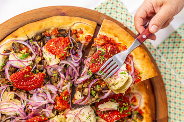 Taking slice of pizza top view with close up