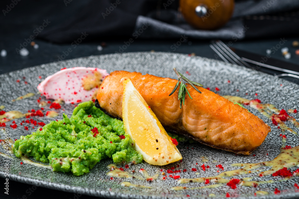 Poster Salmon fillet with broccoli puree, lemon and red caviar, fresh dinner.