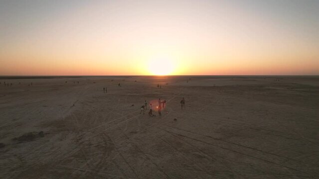 Low drone flight in a salt desert with a sunset. Drone flies forward at low level. General plane