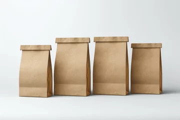 Tuinposter group of four blank brown paper bags on white background © gankevstock