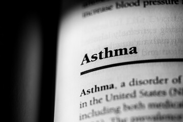 Asthma, respiratory disorder causing breathing issues, printed in black on white page close-up   