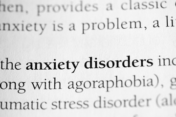 Anxiety disorder, psychology terminology printed in black on white paper close-up. medical treatment and therapy. 