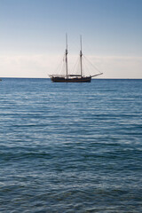 Fototapeta premium Wooden boat with two masts at anchor