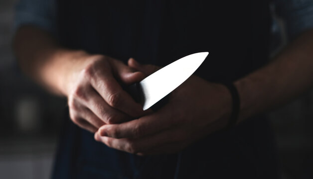 Man'S Hands Grip Kitchen Knife As Chief Prepares To Cook With Sharpened Knife Against Black Background