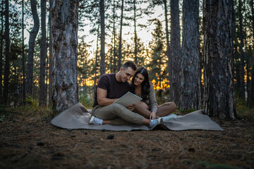 Man and woman young adult couple in nature hold and draw in nature