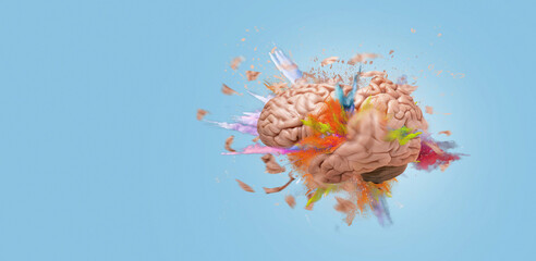 Creative brain explodes with paint splashes on blue background, concept. Think differently and...