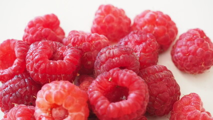 Fresh raspberries on a white background. Ripe juicy fresh raspberries. Organic raspberries, healthy food, vitamins, summer berry fruit. Long banner format. place for text