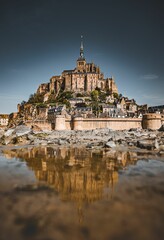 Picturesque view of Mont Saint Michel, an island commune in France, from the banks of the river