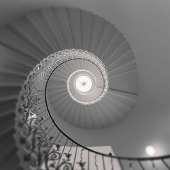 Low-angle of stunning spiral English staircase with intricate designs