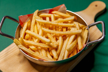 French fries dish top view close up green background