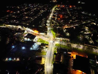 Aerial view of a cityscape at night with streets illuminated with street lamps
