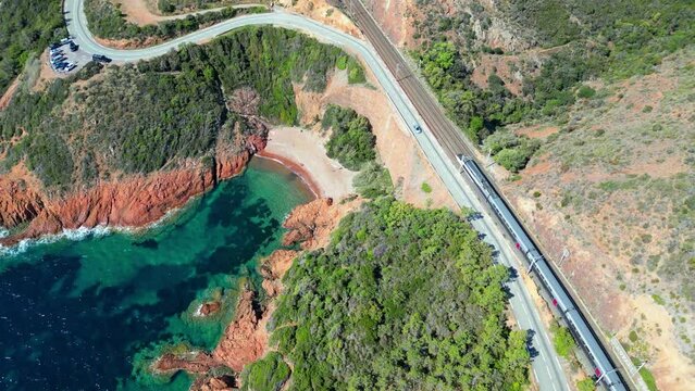 Drone footage of cars on a road over rocky valley by the sea in  Le Trayas, Saint Raphael, France