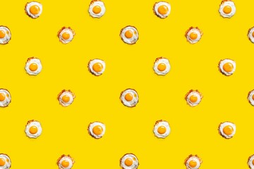 Yellow background with sunny side-up eggs as a pattern for wallpapers