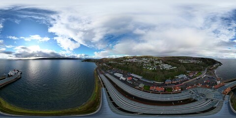 Aerial wide angle view of a small marina, featuring multiple rows of docks