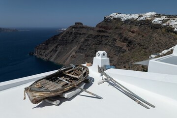 Picturesque view of Imerovigli village in Santorini Island, Greece, featuring an old Wooden Boat