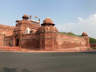 Majestic Red Fort situated in Delhi, India against a cloudy blue sky