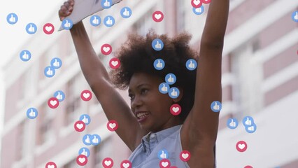 Animation of social media icons over african american holding a placard during a protest