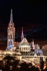 Fototapeta premium Illuminated Matthias Church at night illuminated against a dark sky background