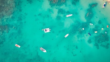 Aerial view of boats moored in the crystal clear turquoise sea. Mauritius, East Africa.