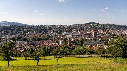 City of St Gallen surrounded by a lush green grassy field