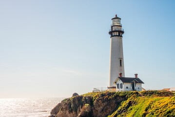 Closeup of a lighthouse on a cliff, a sunny day in coastal California