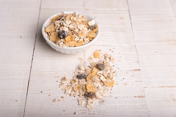 White bowl of oatmeal with some of it spilled on the side