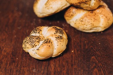 two whole bagels sit side by side on a wooden table