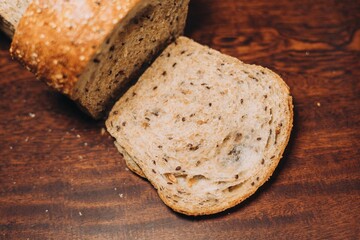 Close-up shot of a freshly sliced loaf of bread on a cutting board