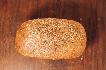 a loaf of bread is shown on a wooden surface with scattered sugar
