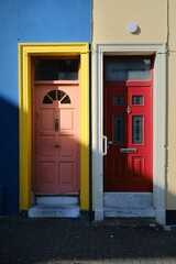 Two colorful doors in a row on a building in Cork, Ireland