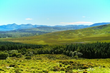 Scenic natural landscape of a vast range of mountains and grassy plains in Irish Kerry