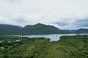Scenic landscape view of a mountain range with a serene lake and rolling hills in Ireland, Kerry