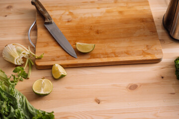 Lime cut into pieces on a wooden board.