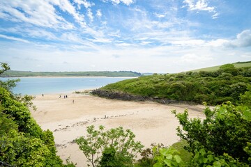 Scenic beach with many people enjoying a sunny day