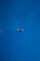 Low angle shot of an airplane flying through a sky