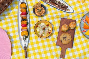 Closeup of various delicious dishes on a blanket for a picnic