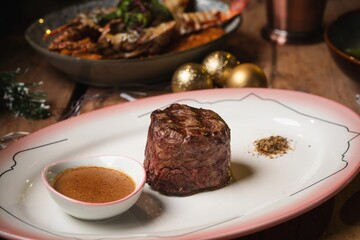 Closeup of steak served on a Christmas-themed table
