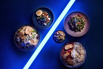 Closeup of various delicious dishes in neon lights