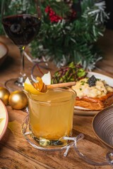 Closeup of a jar of honey on a Christmas-themed table