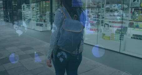 Animation of graphs and gloves over biracial woman scrolling on cellphone while walking on street