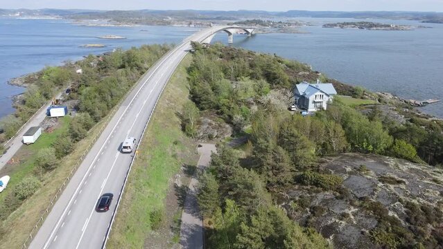 Aerial view of cars driving on a long bridge over fjords in Scandinavia in summer