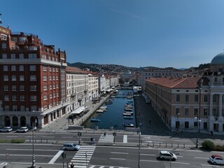 a city street lined with lots of buildings next to water